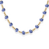 Necklace with blue porcelain beads and gold accents on a white background
