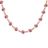 Necklace with pink porcelain beads and gold accents on a white background