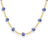 Necklace with blue porcelain beads on a gold chain against a white background