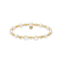 Pearl and gold beaded bracelet on a white background
