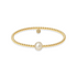 Gold beaded bracelet with a pearl on a white background