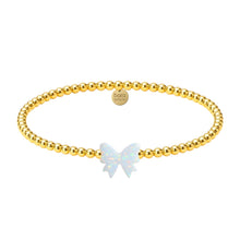 Gold beaded bracelet with a butterfly charm on a white background