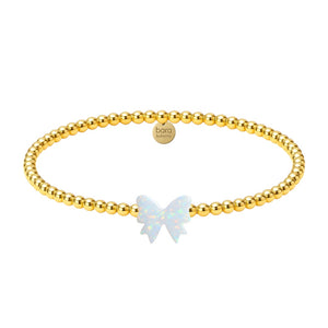Gold beaded bracelet with a butterfly charm on a white background