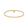 Gold beaded bracelet with a pearl on a white background