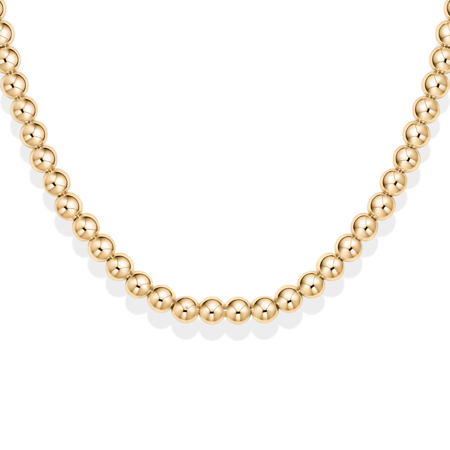 Gold beaded necklace on a white background
