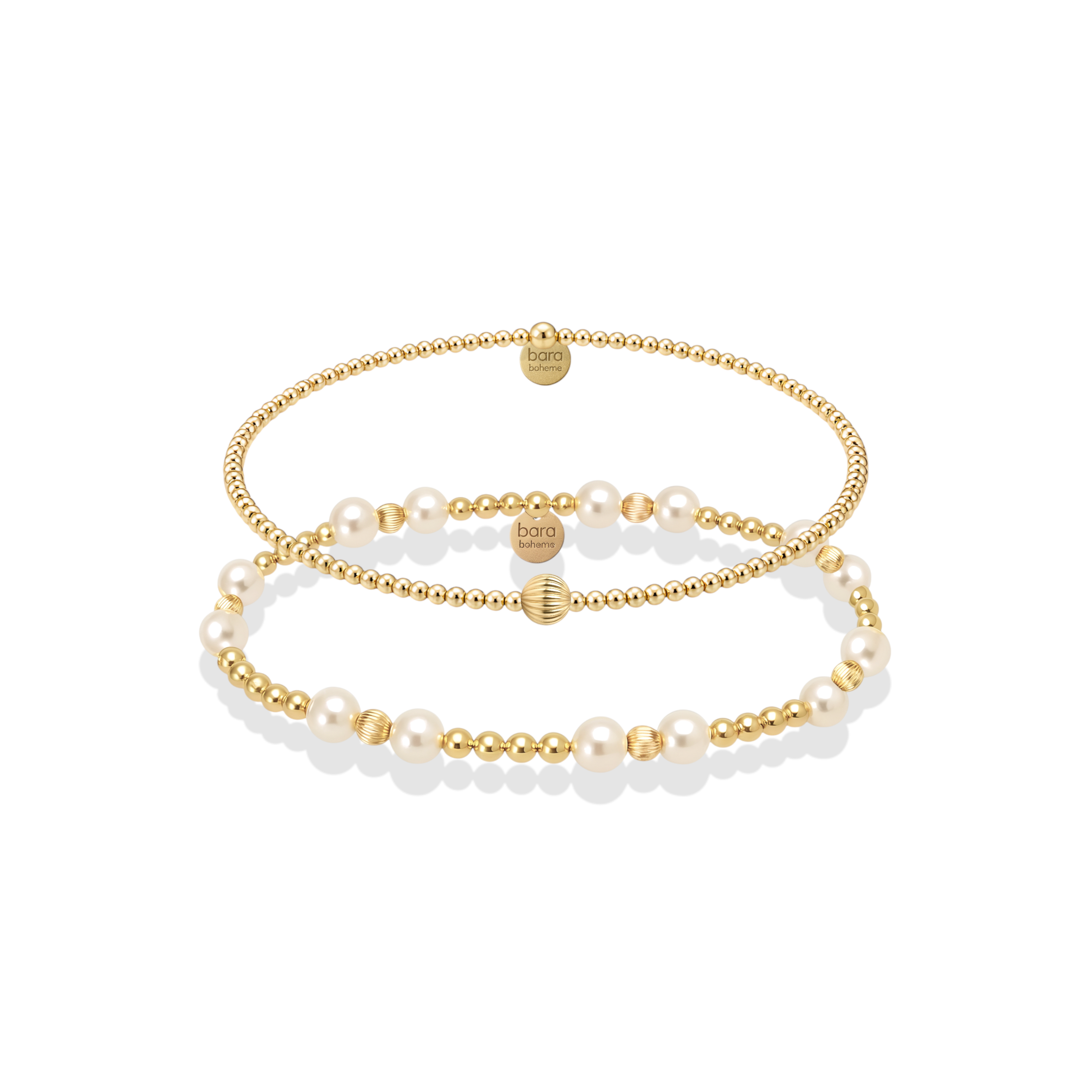 Set of gold and pearl beaded bracelets on a white background