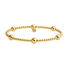 Gold beaded bracelet on a white background