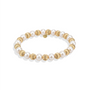 Bracelet with alternating gold and pearl beads on a white background