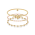 three beaded gold bracelets on a white background