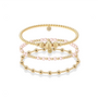 three beaded gold bracelets on a white background