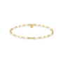 Gold and pearl beaded bracelet on a white background