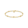 Gold and pearl beaded bracelet on a white background