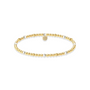 Gold and pearl beaded bracelet on a white background