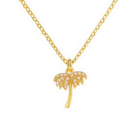 Gold palm tree necklace on a white background