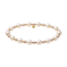 Pearl bracelet with gold accents on a white background