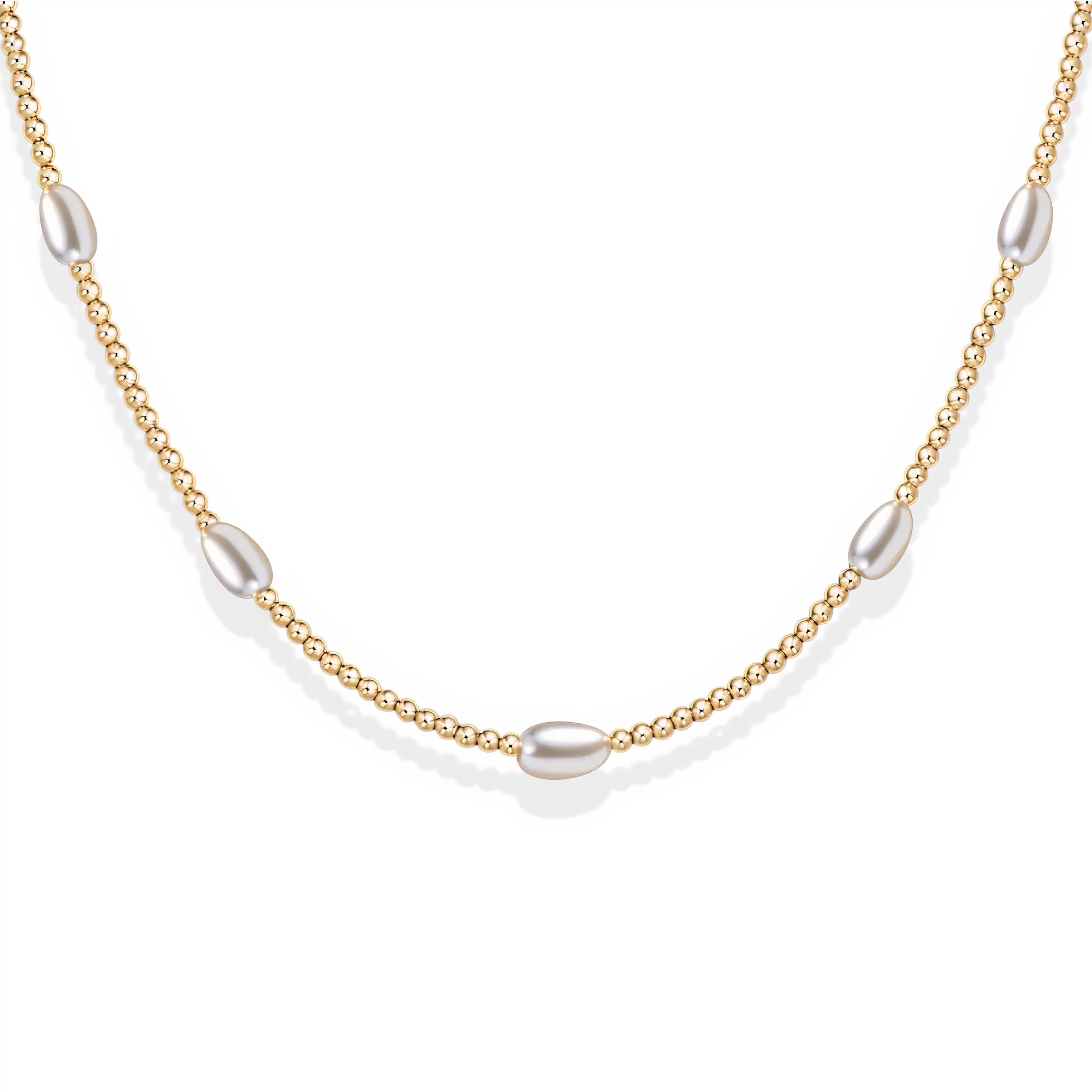 Gold beaded necklace with pearls on a white background