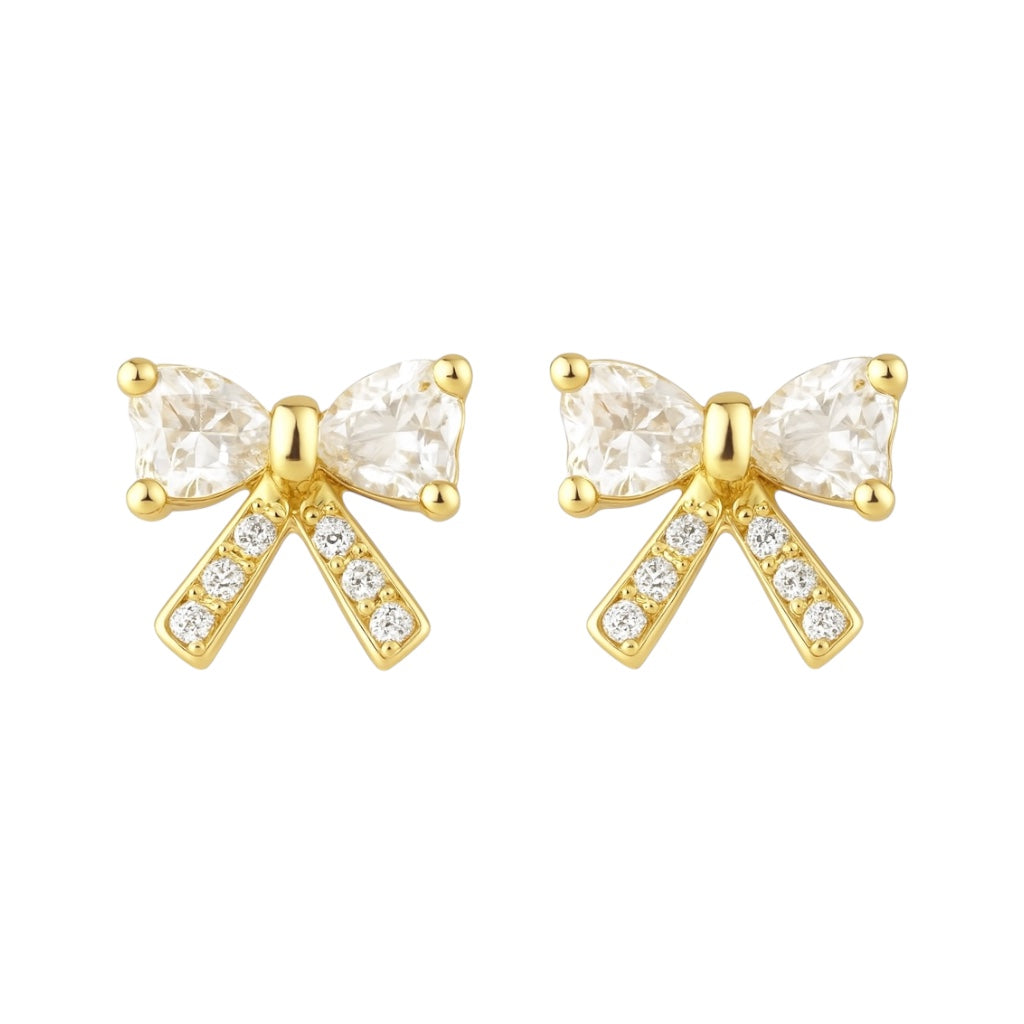 Gold bow-shaped earrings with clear gemstones on a white background
