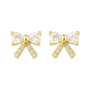 Gold bow-shaped earrings with clear gemstones on a white background