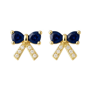 Gold bow-shaped earrings with blue gemstones on a white background