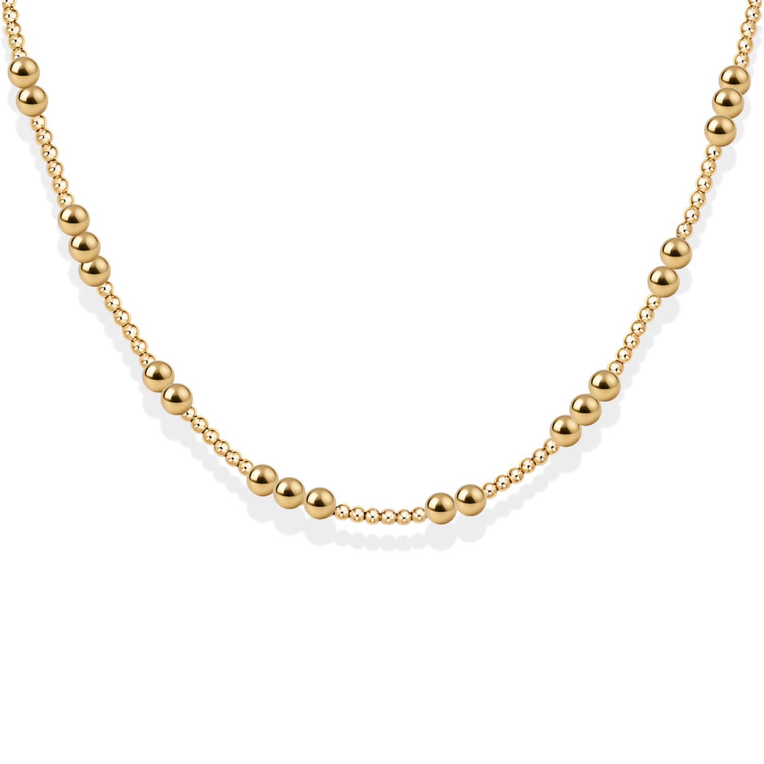 Gold beaded necklace on a white background