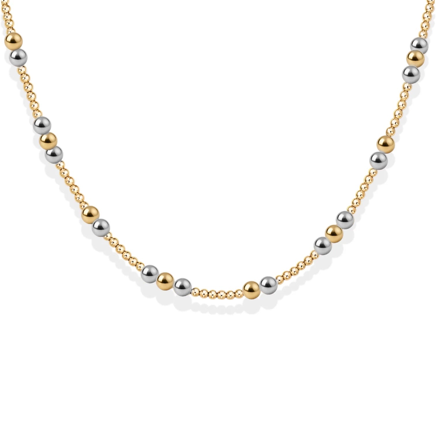 Necklace with alternating gold and silver beads on a white background