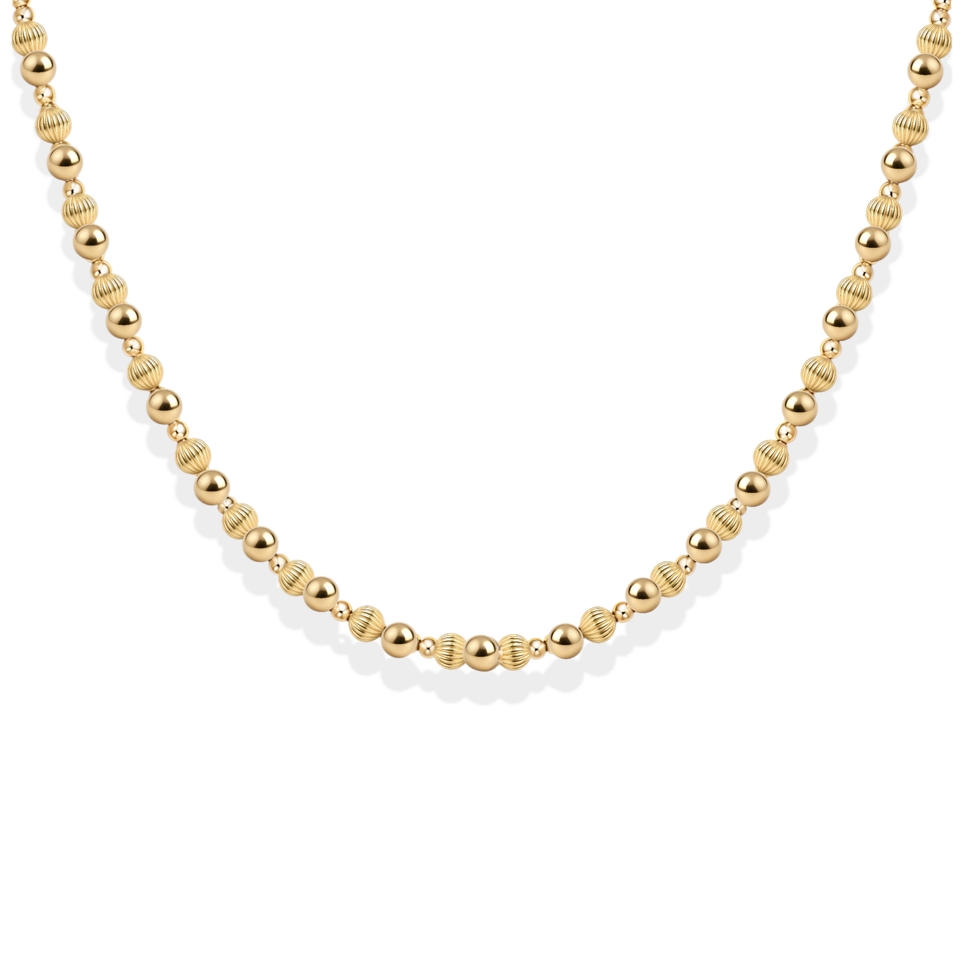 Gold beaded necklace on a white background