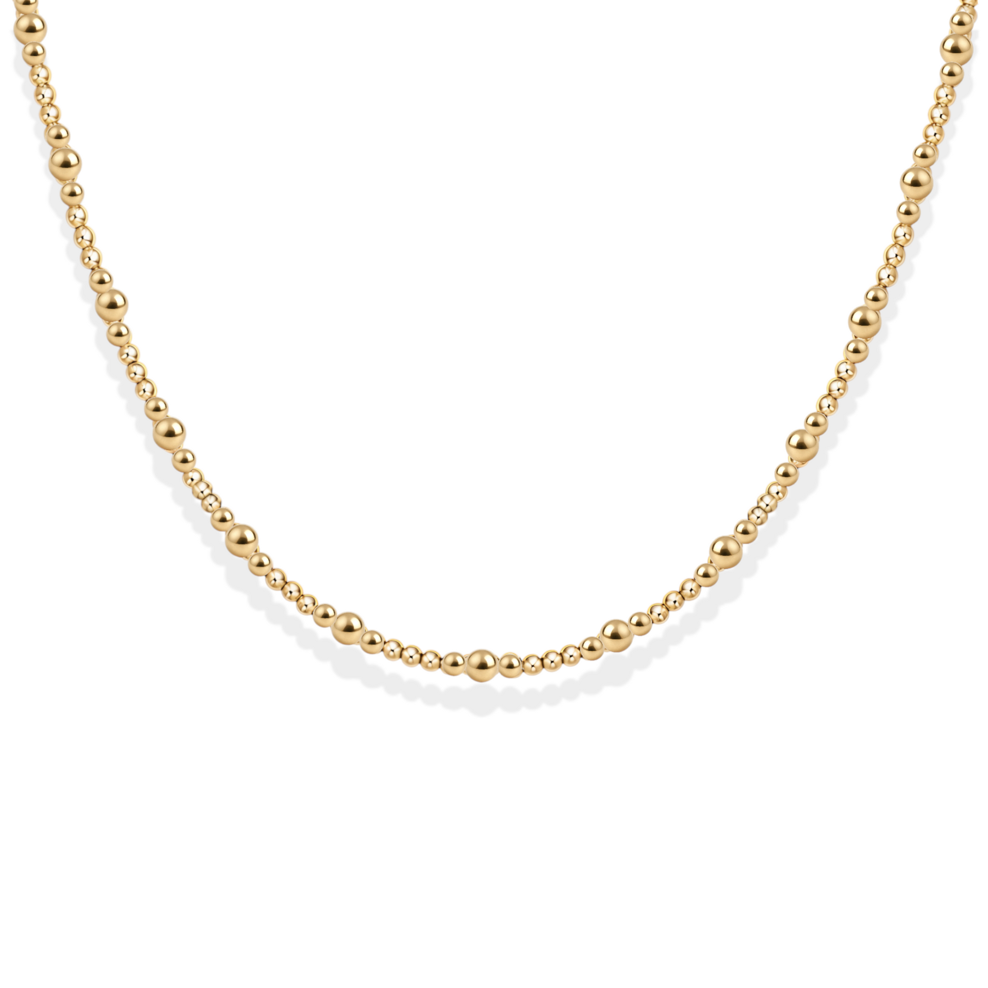 Gold bead necklace on a white background