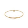 Gold beaded bracelet on a white background