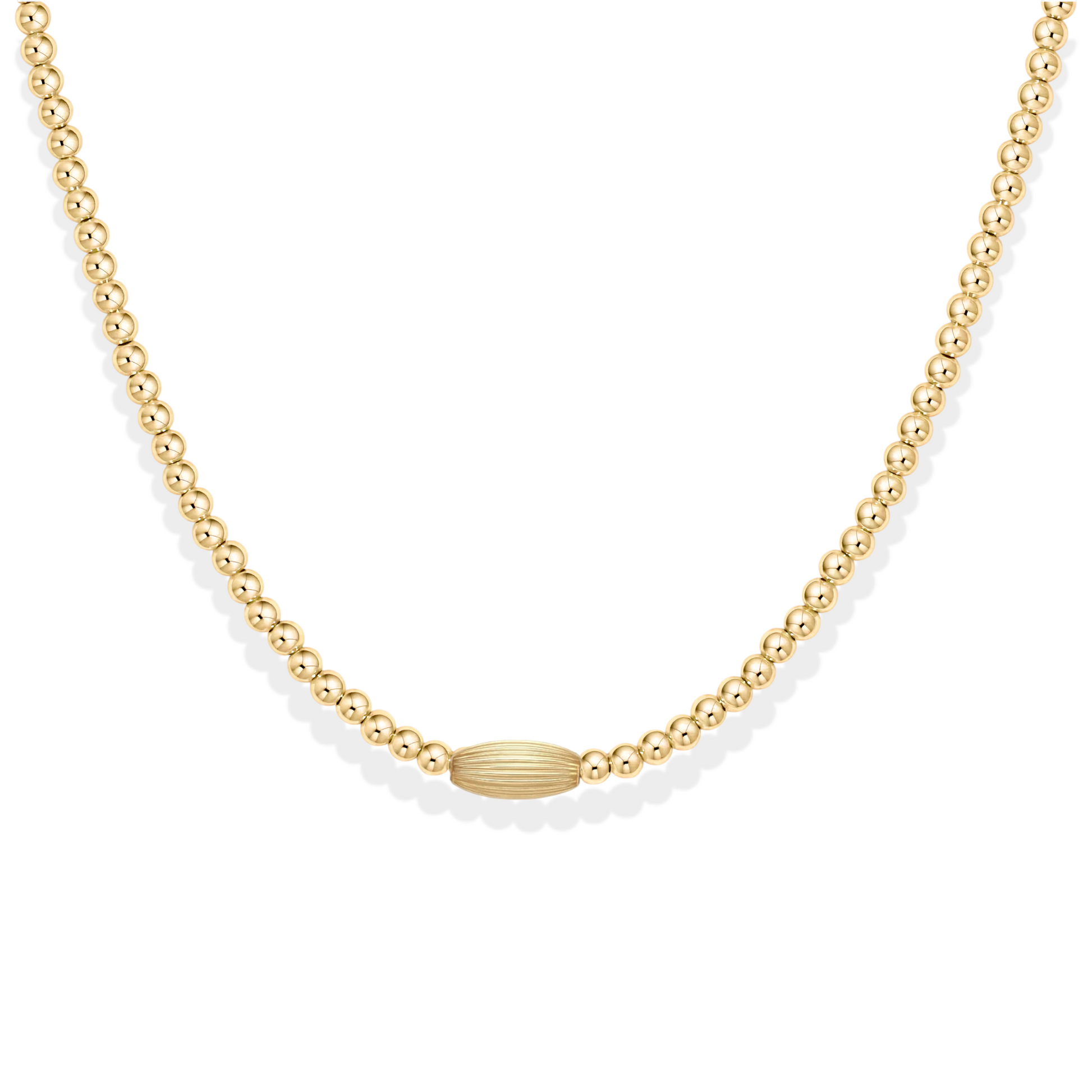 Gold beaded necklace with a small oval bead on a white background