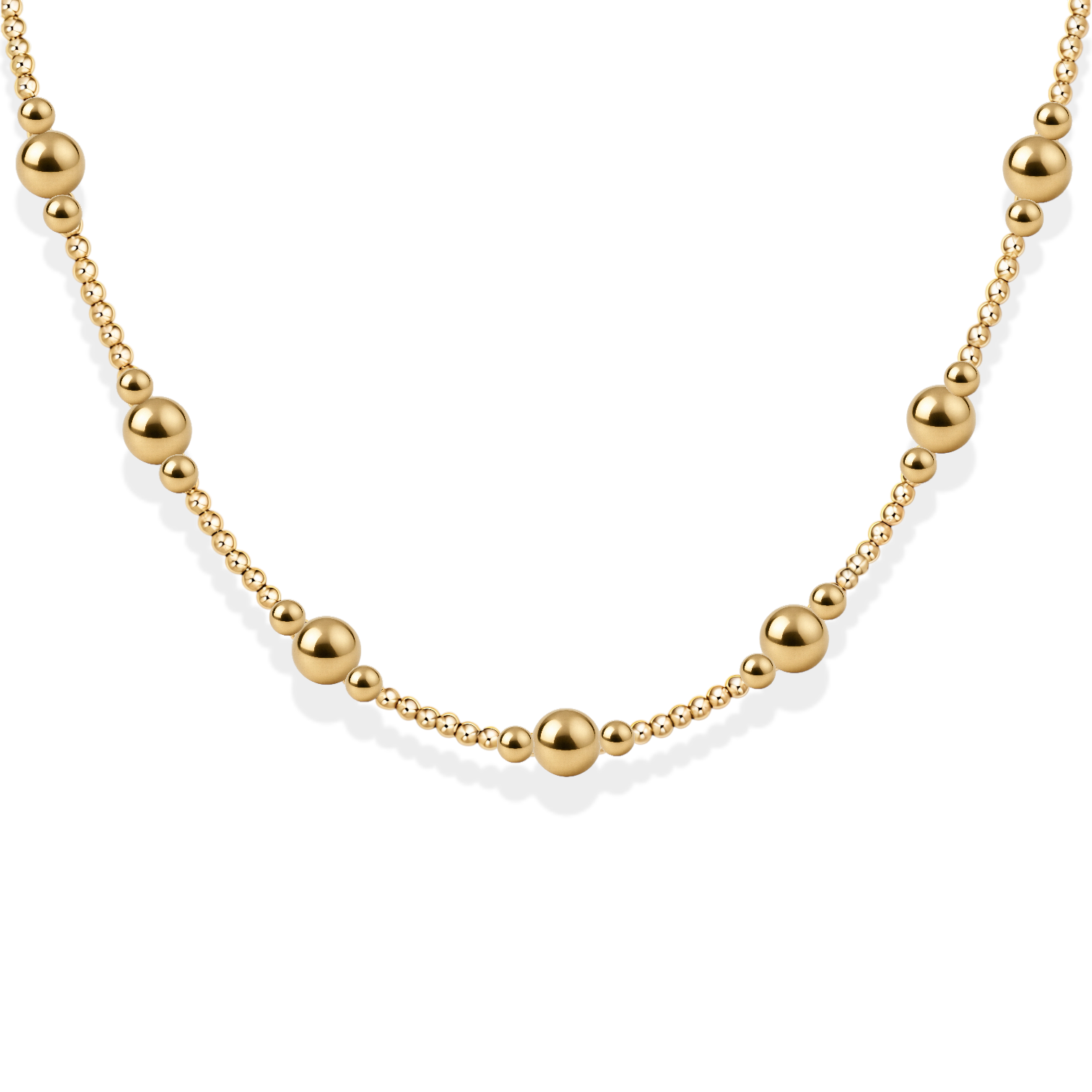 Gold necklace with round beads on a white background
