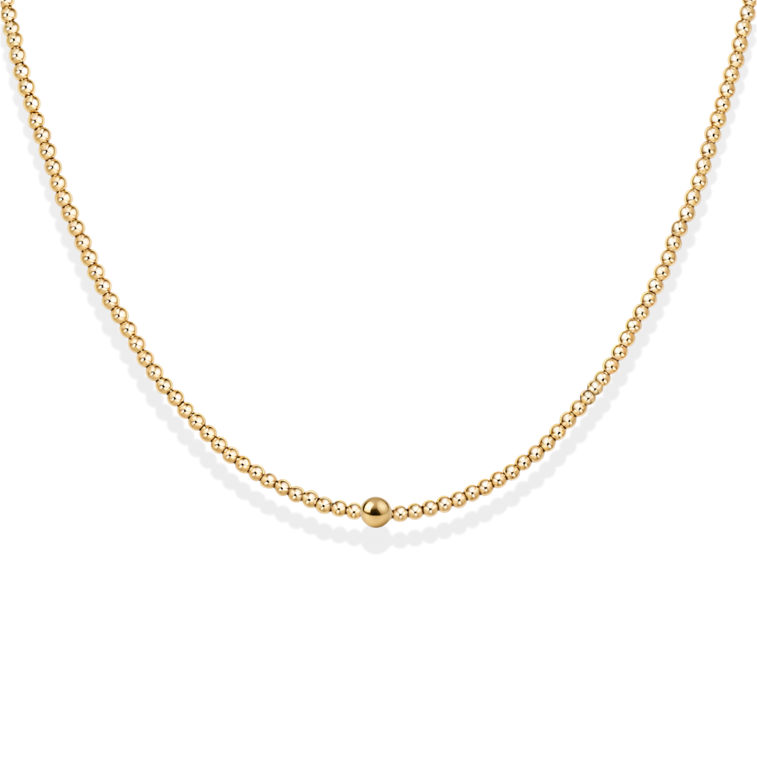 Gold necklace with small beads on a white background