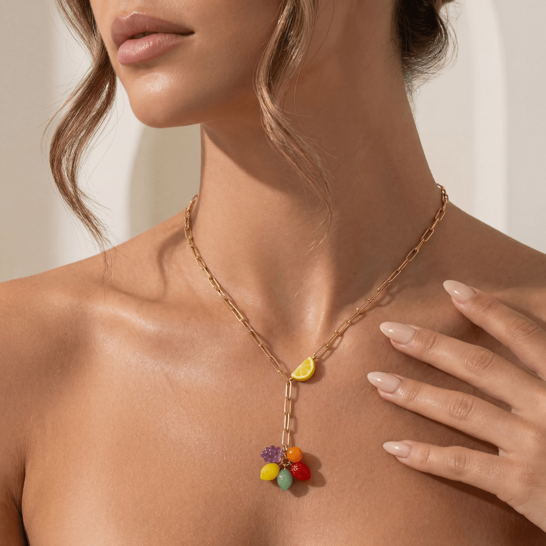 Necklace with colorful pendant worn by a model on a neutral background